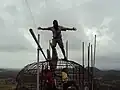 The artistic adviser Joseph Alaban on the top of the head armature of the statue.