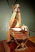 King of Rome's Cradle (Empire); by Pierre-Paul Prud'hon, Henri-Victor Roguier&nbsp;[fr], Jean-Baptiste-Claude Odiot and Pierre-Philippe Thomire; 1811; wood, silver gilt, mother-of-pearl, sheets of copper covered with velvet, silk and tulle, decorated with silver and gold thread; height: 216&nbsp;cm; Kunsthistorisches Museum (Vienna, Austria)