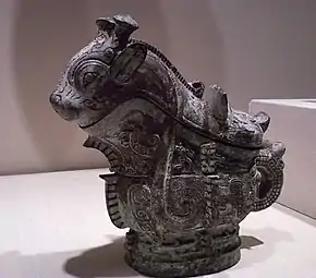 Ritual wine server (guang); 1100 BC; 21 × 22.9&nbsp;cm (8.25 × 9 in); Indianapolis Museum of Art. Adorning the surface of the vessel are three primary decorative animal motifs, including fifteen imaginary creatures cast in relief along the sides