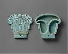Cosmetic box in the shape of an Egyptian composite capital, its cap being in the left side; 664–300&nbsp;BC; glassy faience; 8.5 × 9&nbsp;cm (3.4 × 3.5&nbsp;in); Metropolitan Museum of Art