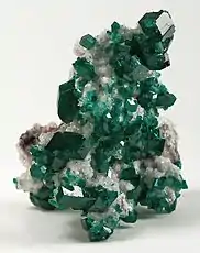 Dioptase crystals on calcite, a classic Tsumeb specimen. Size: 8.2 x 5.8 x 5.5&nbsp;cm