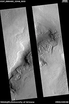 Wide view of dipping layers, as seen by HiRISE under the HiWish program.  The dark strip is where a computer problem is preventing the gathering of data.
