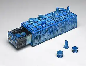 Senet  gameboard, with counters and sliding drawer to contain them, ca. 1390-1353 BC, Brooklyn Museum. Blue faience with ornament and markings in black. Inscribed with Horus name of King Amenhotep III.