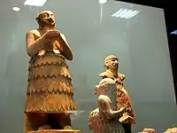 Ishqi-Mari (forefront, in profile), before larger figures.