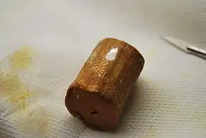 Oxidised sodium after improper storage under contaminated hexane showing an orange crust of sodium superoxide.