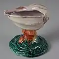 Salt, coloured glazes, moulded in relief, circa 1880, naturalistic shell.