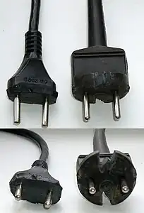 Moulded rubber Soviet plugs cut with knife so that they can fit into CEE&nbsp;7/3 socket. Originally the plugs had a round base.