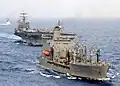 John Lenthall, right foreground, prepares to refuel the aircraft carrier USS&nbsp;Harry S. Truman, aft left, in the Mediterranean Sea.