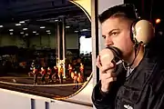 YN2 Patrick Shuman mans his station as deck control phone talker during a replenishment at sea (RAS) between Military Sealift Command (MSC) USNS&nbsp;Bridge (T-AOE-10) and USS&nbsp;Nimitz (CVN-68).