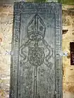 La pierre tombale de Charles Jegou, abbé de l'abbaye de Daoulas entre 1519 et 1535.