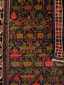 Tapis afghan à décor de chars, de grenades et de Kalachnikovs, Le Grand Jeu, coll. Michel Aubry, vu au musée de la tapisserie de Beauvais en 2012.