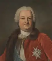 Peinture à l'huile représentant un homme assis vêtu d'un gilet bleu-azuré, d'une veste rouge carmin bordée d'une fourrure marron et ornée d'une étoile d'argent, le crâne couvert d'une perruque blanche et bouclée.