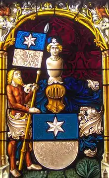 Peinture sur verre vivement colorée représentant un personnage en armure soutenant un drapeau bleu et blanc.