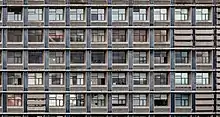 Façade de 10 x 5 petites fenêtres de petits appartements.