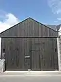 Entrée du chantier (hangar), sur la rue Jean Jaurès