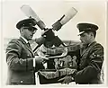 A gauche, Nathan Landman, rabbin aumônier de l'Armée de l'air pour la France, l'Espagne et la Libye, examine le shofar et d'autres équipements religieux du grand jour avant de décoller de la base aérienne d'Evreux-Fauville (France) pour Tripoli (Libye), lors de la première étape d'un circuit de 3&nbsp;000 milles dans lequel il effectue huit services sur cinq bases avant de revenir à Evreux pour Yom Kippour. À droite, le spécialiste des services d'aumônerie juive, David Cohen d'Everett (Massachusetts), septembre 1964
