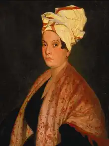 Portrait sur fond noir d'une femme au teint clair, un châle sur les épaules, coiffée d'un turban.