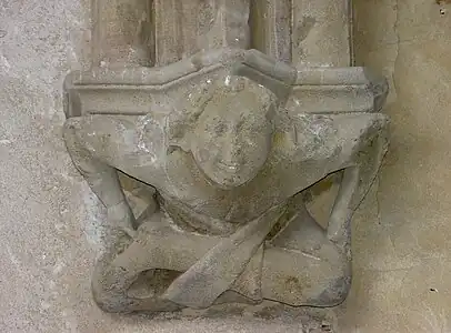 Console d'une des travées de la galerie est de l'abbaye d'Abondance, représentant un petit acrobate souriant, XIVe&nbsp;siècle.