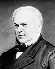 Détail en N et B d'un tableau. Forster, ami et premier biographe de Dickens, 60&nbsp;ans environ, visage épais, cheveux blancs, regard sévère et perçant