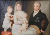 Huile sur toile représentant Louis-Philippe, tête-nue, en habit noir sur un pantalon crème, Marie-Amélie en robe perle les cheveux recouverts d'un léger voile long, tenant Louise sur ses genoux et Ferdinand derrière elle.