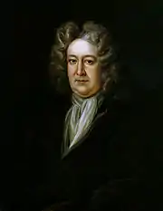 homme, la cinquantaine, visage coloré et poupin sur fond assez sombre