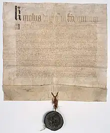 Ordonnance de Charles V, scellée du sceau royal de cire verte pendant sur lacs de soie rouge et verte, 1374. Archives nationales AE-II-395.