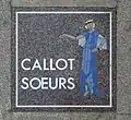 Plaque sur le sol, avenue Montaigne (Paris).
