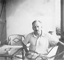 Photographie d'un homme assis à une table.