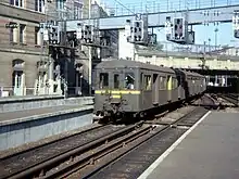 Un élément Standard alimenté par troisième rail entre en gare de Paris-Saint-Lazare sur les voies du groupe II en septembre 1976. La caténaire 25 kV est déjà en place.