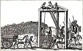 Une illustration monochrome d'une structure à trois pieds avec des poutres pour relier chaque pied au sommet (formant un triangle équilatéral sur son côté). Plusieurs hommes sont assis en haut de la structure, près d'une échelle, à environ 600 mètres de haut. Une corde relie le sommet de la structure au cou d'un homme, debout sur une charrue. Un autre homme lit un livre, tourné vers lui. Des chevaux tirent une autre charrue, sur laquelle on peut voir deux cercueils. Une grande foule est réunie au loin, regardant la scène.