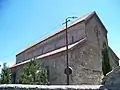 cathédrale en plan rectangulaire au sol, de structure basilicale, édifiée avec des pierres de teinte rosâtre et dont la nef est flanquée sur toute sa longueur de deux bâtiments recouverts de tuiles rouges.