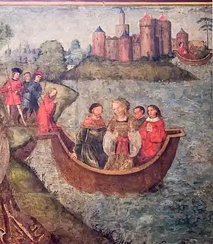 Jésus, assis derrière une table, accompagné par quatre hommes. Devant eux, agenouillée, une jeune femme plonge la main dans un vase.